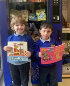 image of two children holding books as part of the reading stars for week 23rd Jul 24